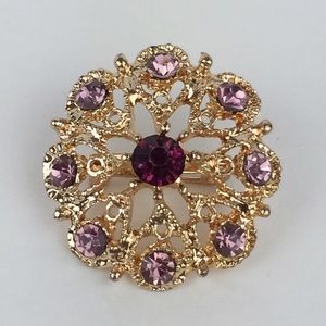 Vintage Gold tone brooch with pink/purple crystals